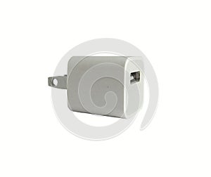 Old white mobile adapter charger and USB port plug on white background