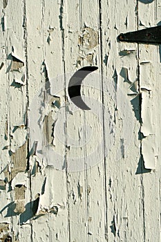 Old white outhouse moon door
