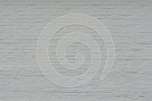 Old white painted brick wall. White background with cracked brick texture with a large layer