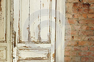 Old, white painted doors, closed, indoors with red brick wall