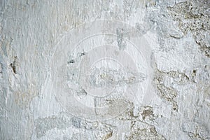 Old white painted limewashed plaster wall texture or background. Close-up
