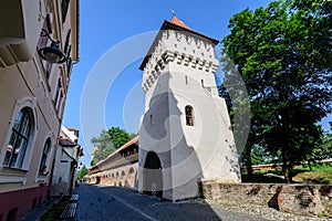 Old white painted stone tower in the historical center of the Sibiu city, near Citadel Street and Park (Strada si Parcul