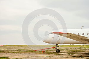 Old white passenger plane with a cruel hitch for transportation