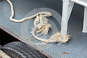 Old white rope tied to steel