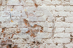 Old white almost ruined brick wall texture
