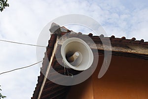 Old white speaker in the corner of an old mosque