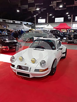 Old white sport 1973 Porsche 911 RSR Carrera speedster coupe on the red carpet. Classic car show