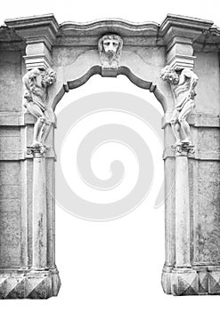 Old white stone entrance with statues that support the columns.