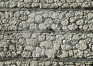 Old white stone wall  with wooden beams closeup