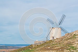 Old white traditional windmill on the hill near Consuegra Casti