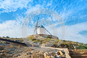 Old white traditional windmill on the hill near Consuegra Casti