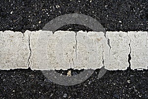 Old white traffic lines on the road