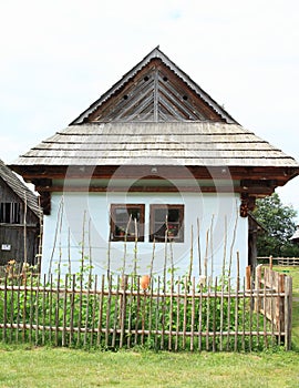 Old white village house with garden in open-air museum