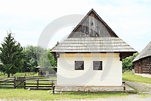 Old white village house in open-air museum