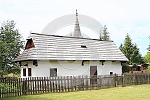 Old white village house in open-air museum