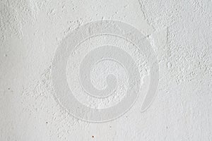 An old white wall with texture is decorated with cement mortar