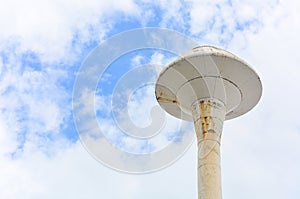 Old white water tank tower with clouds and blue sky background, clipping path