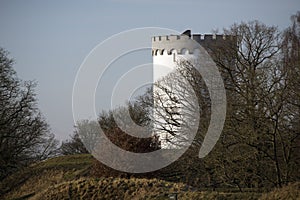 Old white water tower on rampart in Danisc city.