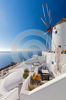 Old white windmill in Oia in Santorini, Greece. Tradition white buildings of famous Santorini island