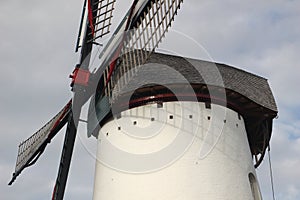 Renovated old white windmill