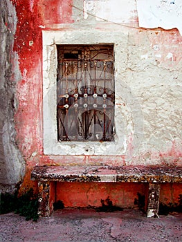 Old white window, the backdrop of an old red wall