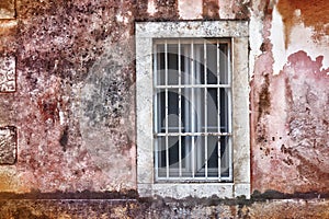 Old white window, the backdrop of an old red wall