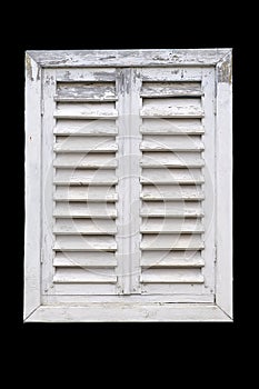 Old white window with wooden shutters.