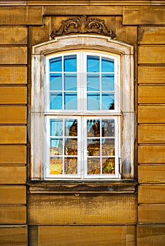 Old white window and yellow building facade, Copenhagen, Denmark