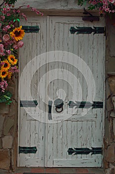 Old white wooden door decorated with flowers