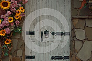 Old white wooden door decorated with flowers