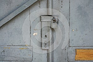 Old white wooden door and rusty lock