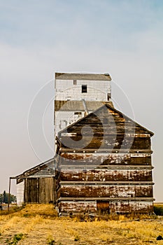 Old white wooden grain elevator by the tracks. Skiff, Alberta, Canada