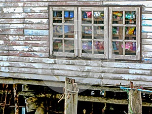 Old white wooden house in fisherman`s village.