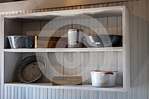 Old white wooden shelf in a kitchen, interior of a house from the antique west