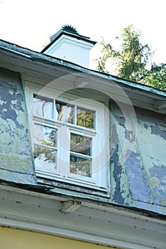 Old white wooden window with layout and rebate roof photo