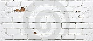 Old, Whitewashed Brick Wall With Damaged Plaster. Texture Of Damaged White Brickwork.