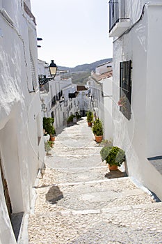 The old whitewashed Spanish village of Frigiliana,on the Costa del Sol.  A steep alley with tighthly packed houses.