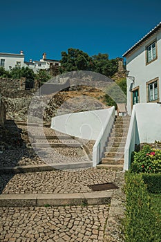 Old whitewashed wall house with stairs and green garden