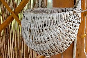 An old wicker basket hanging on the wall.