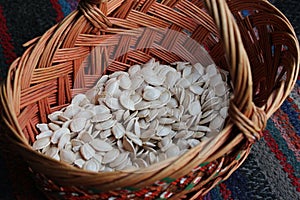 Old wicker wooden basket with pumpkin seeds.