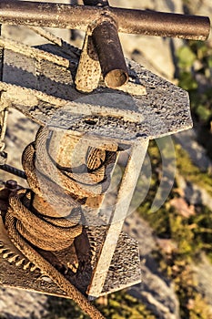 Old Winch With Rusty Gear Wheel And Corroded Steel Cable Coil Detail