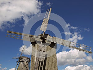 Old windmill at the background of the blue sky