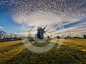 Old windmill with a beautiful sky and clouds photo