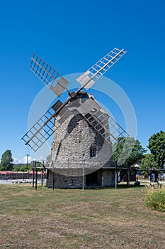 An old windmill with a blue sky background