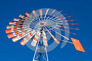 An old windmill with a cloudless blue sky