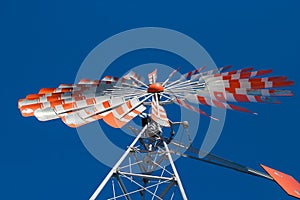 An old windmill with a cloudless blue sky