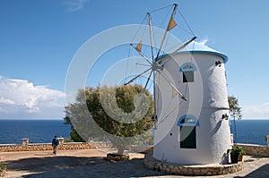 Old windmill on Greece island on the sea beach