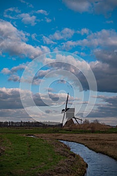 An old windmill known as Broekmolen at the edge of the river in autumn. Technology used to drain marshy land
