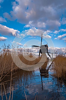An old windmill known as Broekmolen at the edge of the river in autumn. Technology used to drain marshy land