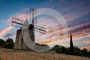 Old windmill known as `moulin de Daudet` at sunset in Fontvieille, Provence, France photo